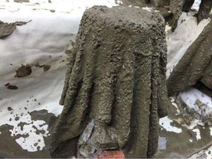 将毛巾从水泥砂浆中捞出来